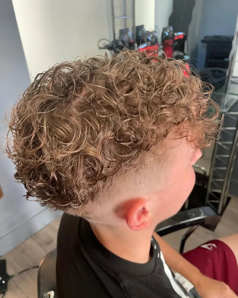 Men's perm creating loose textured waves with a relaxed, natural finish top view