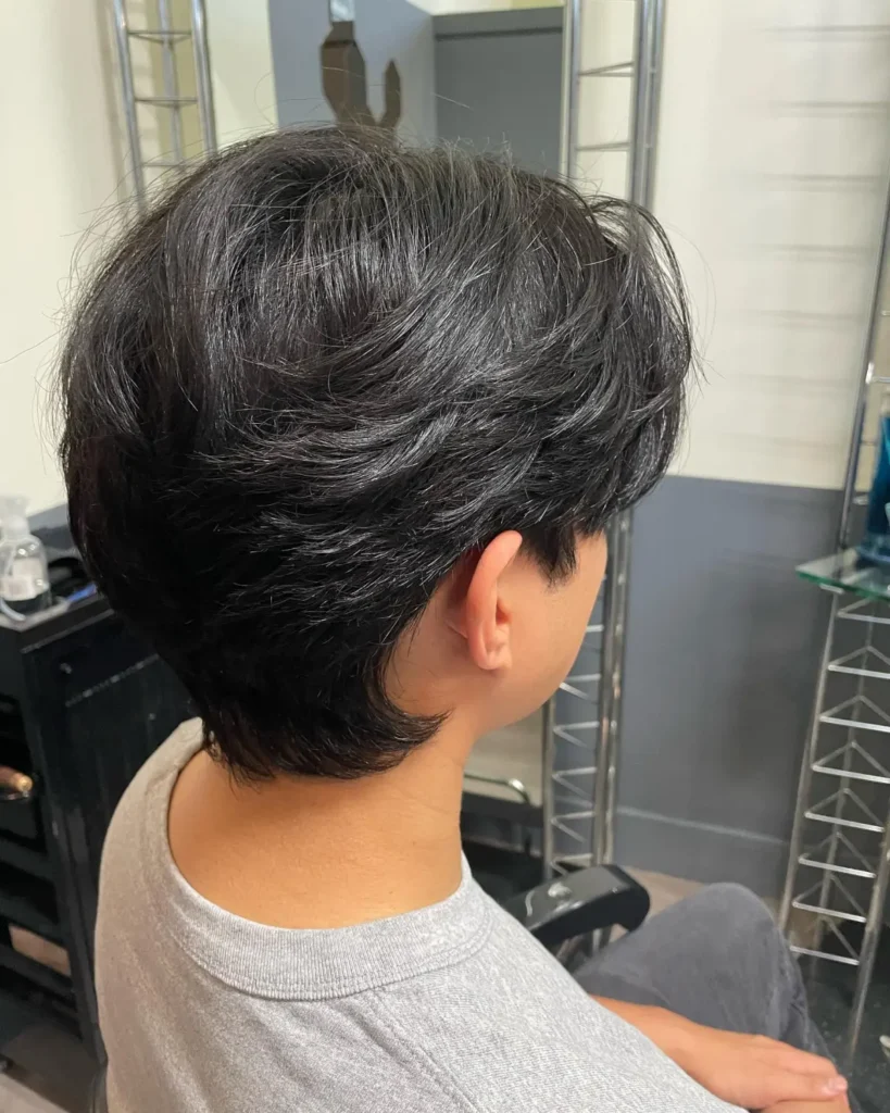 Men's leaf cut with lightweight, feathered ends and soft outward-facing layers side view