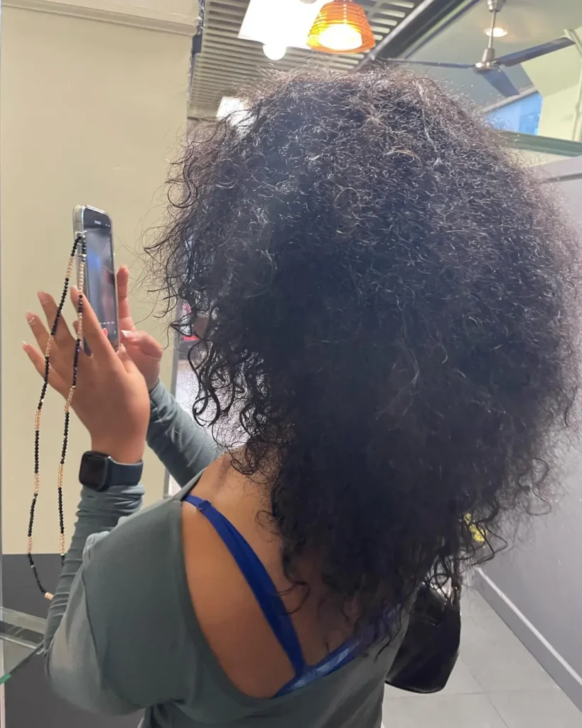 Before Korean layered haircut on curly hair — heavy, undefined curls