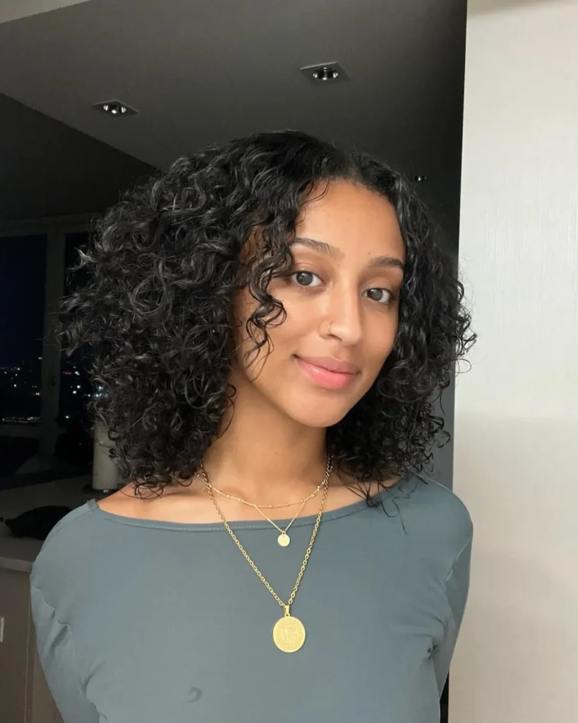 After Korean layered haircut on curly hair — lighter, defined curls with movement