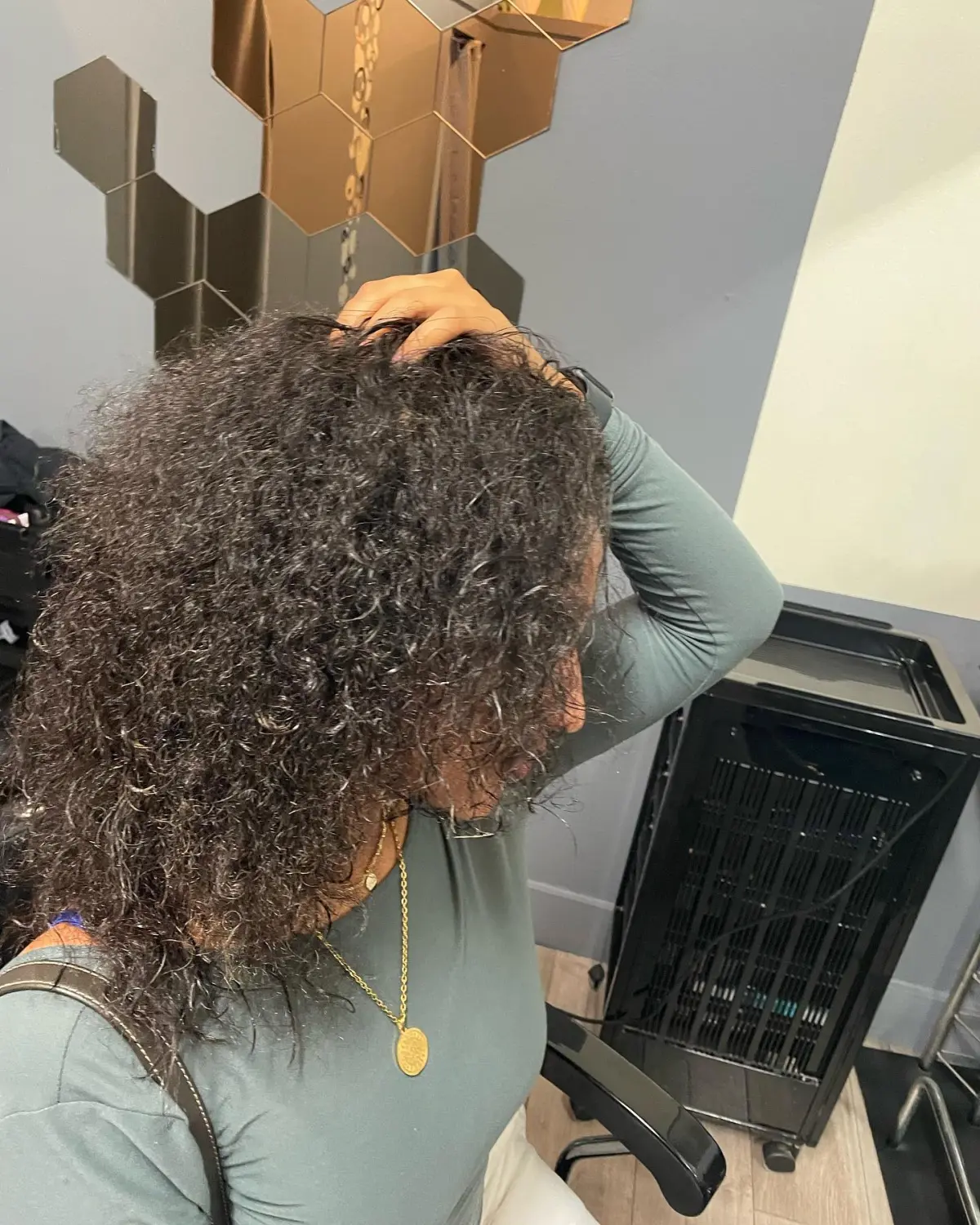 Korean-inspired layered haircut on curly hair, side profile view