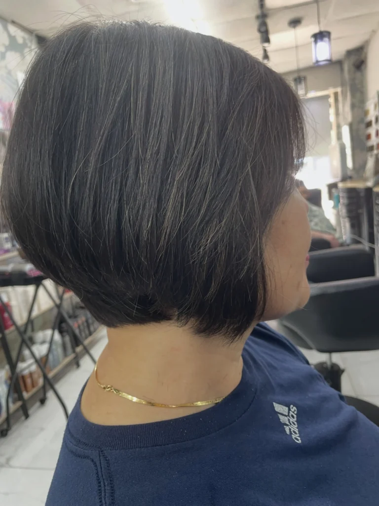 A chin-length Korean bob with soft inward curve and airy, face-framing volume — polished but never stiff.