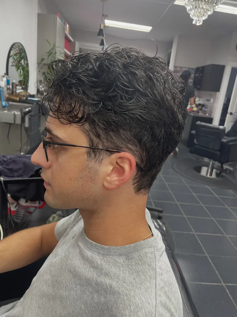 Korean two-block haircut with clean tapered sides and textured length on top side view