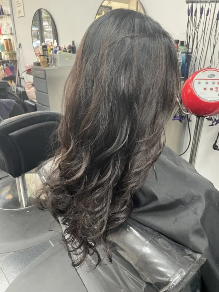 Right side profile view of a Korean digital perm hairstyle, featuring soft, natural-looking loose waves with smooth root-to-end movement and a glossy, healthy finish.