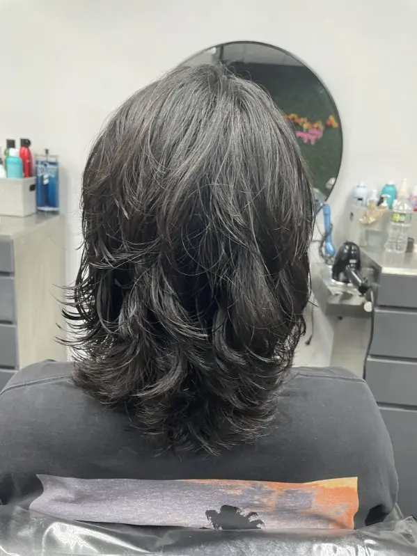 Men's medium layered haircut, back view