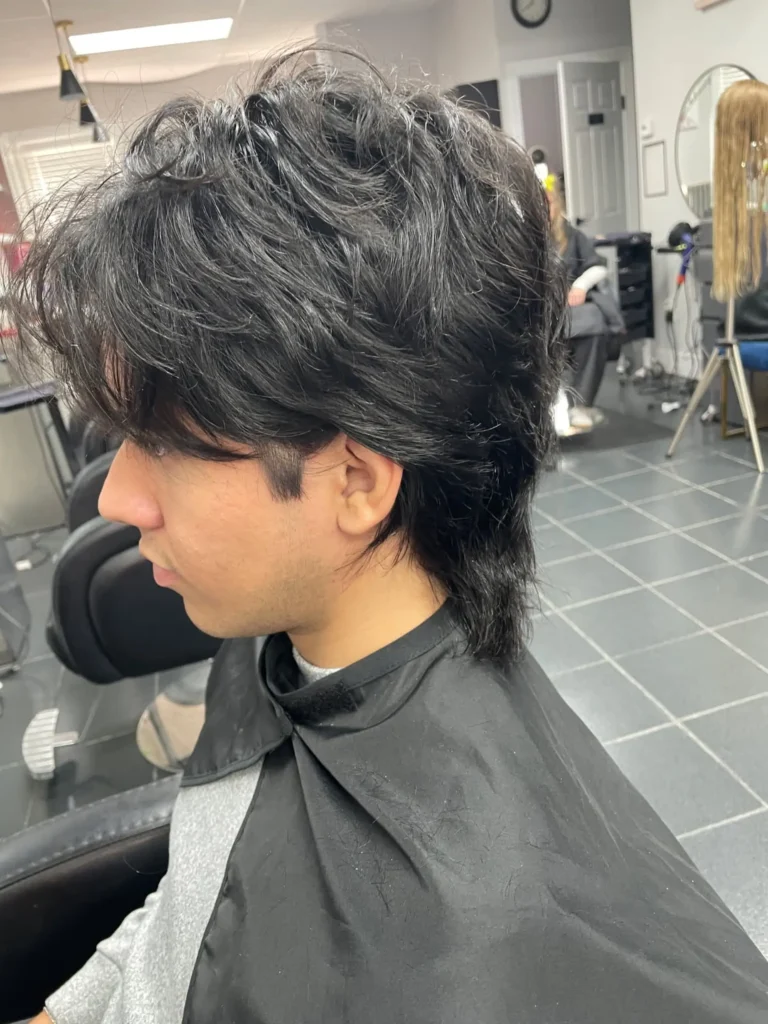 Man with a shaggy wolf cut hairstyle front side view